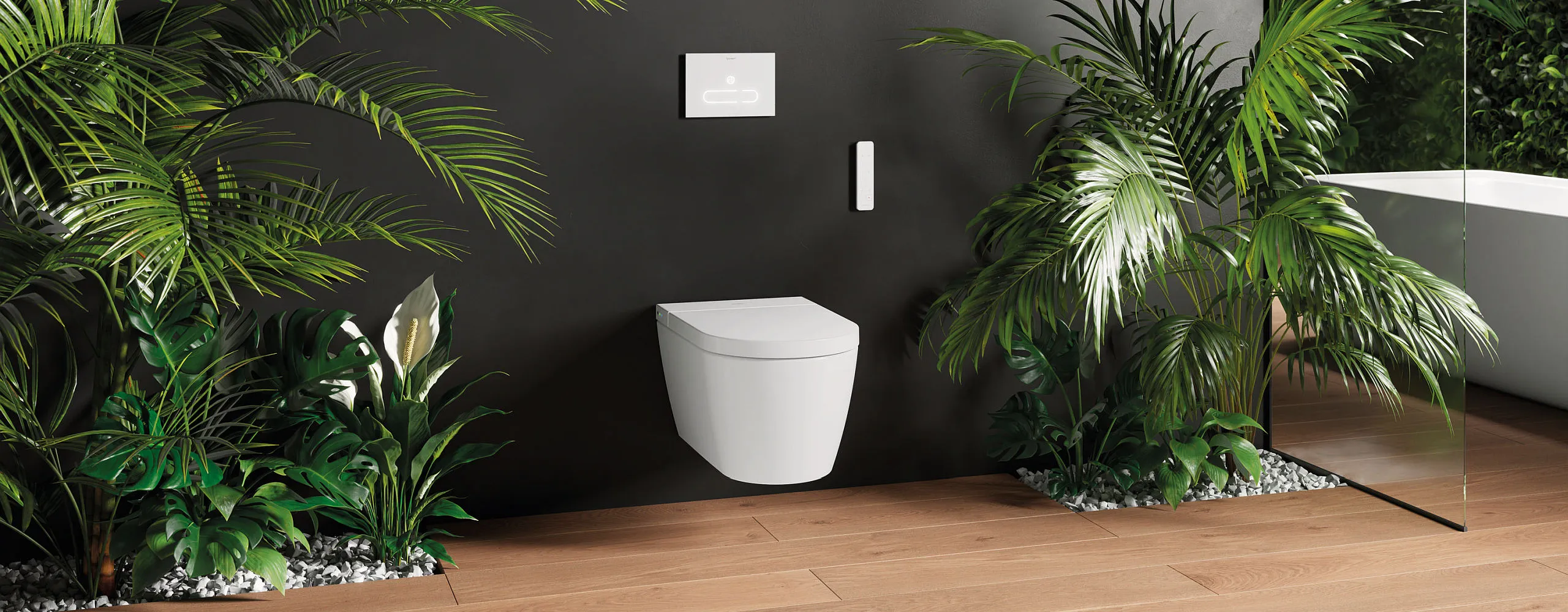 Weißes, wandhängendes Dusch-WC Starck f von Duravit vor dunkler Wand. Daneben stehen auf beiden Seiten große Pflanzen, die eine angenehme Atmospähre schafen.